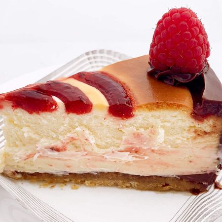 white raspberry chocolate cheesecake slice